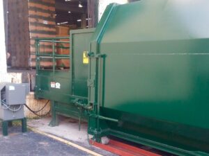 Stationary compactors and rolloff compaction containers