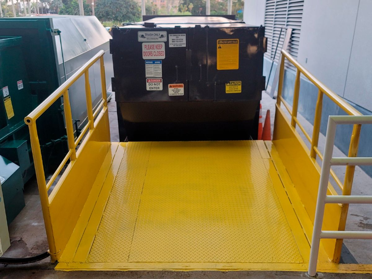 Stationary compactors and rolloff compaction containers