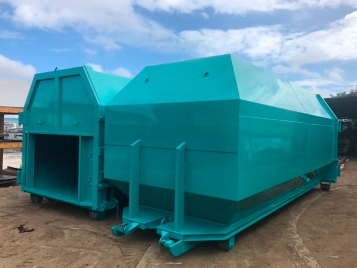 Stationary compactors and rolloff compaction containers